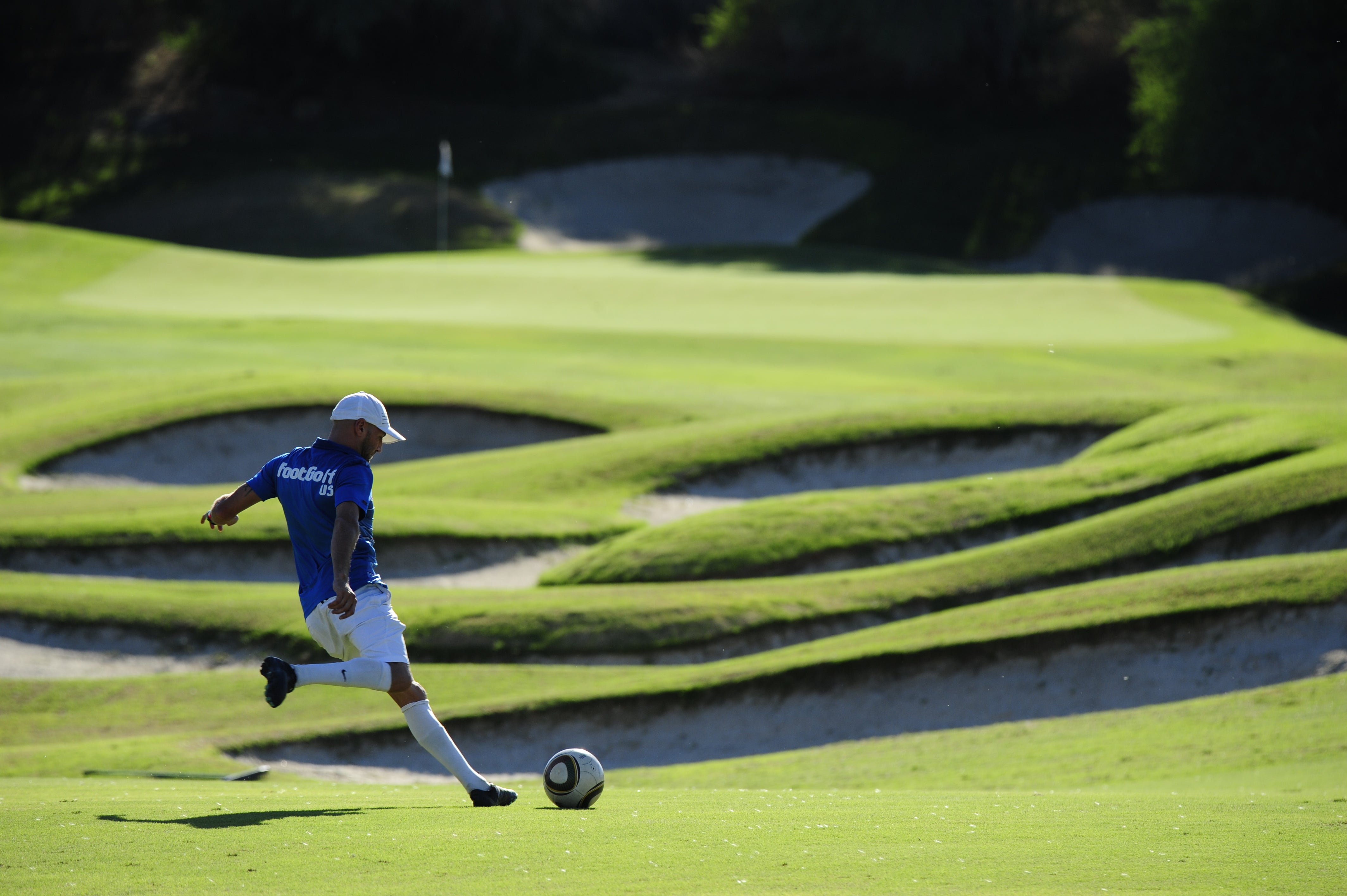 Image of FootGolf player approaching the ball mid-swing on the fairway