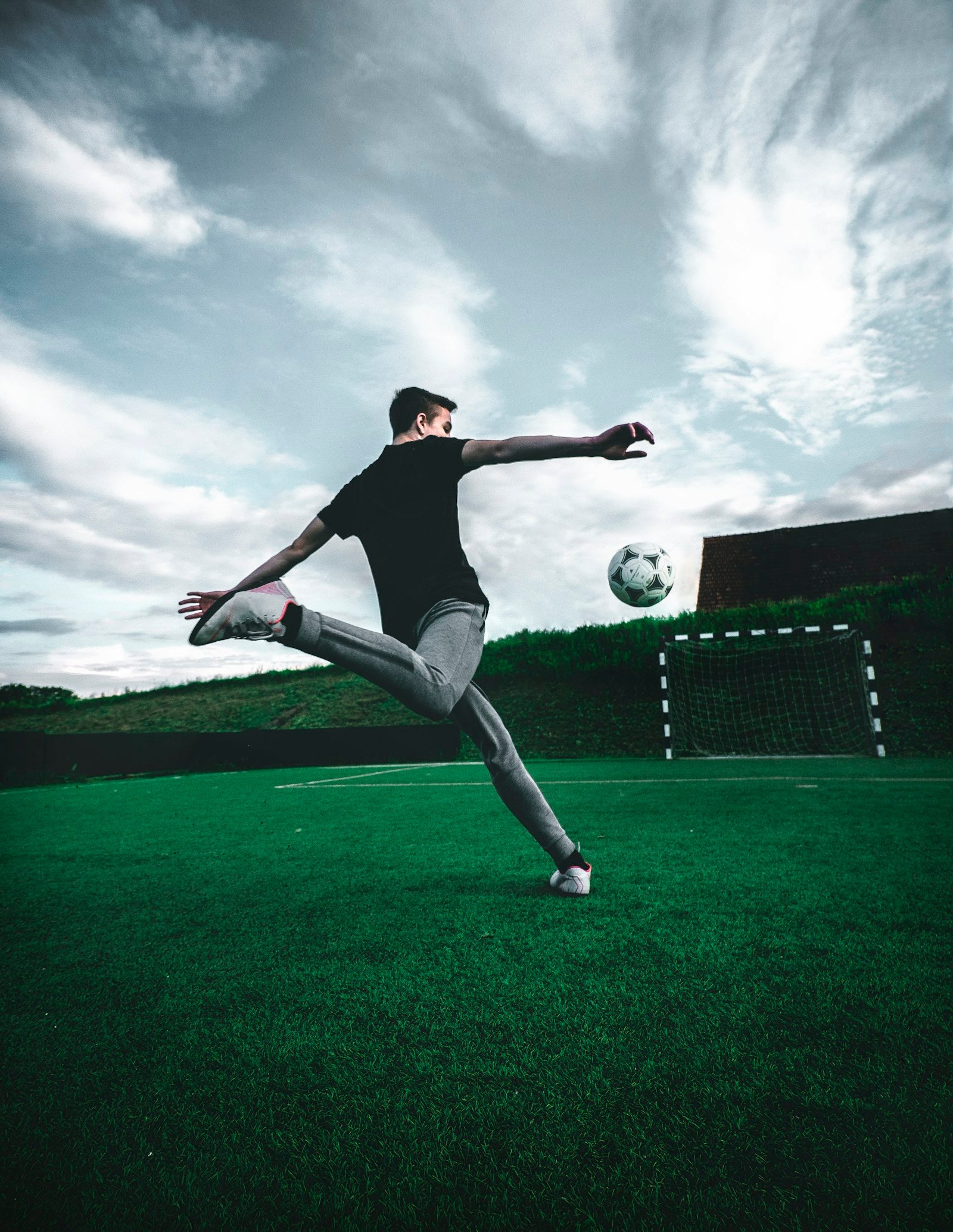 Image of Footballer in action on the pitch, mid-strike